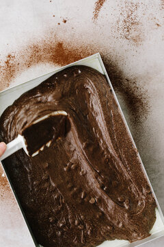 Spreading brownie cake batter into baking tin