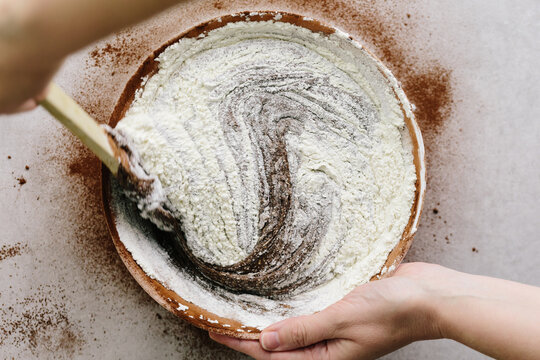 Woman mixing flour into brownie mixture