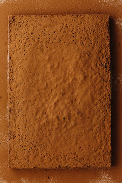 Baked sheet brownie uncut with cocoa powder