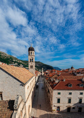 View of the famous Stradun street in the old town of Dubrovnik, as seen from above while climbing the city walls. Long narrow street surrounded by old houses