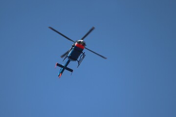Fototapeta na wymiar fliegender Hubschraumer vor blauem Himmel