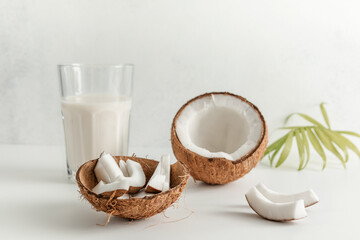 coconut and coconut milk in a glass Cup on a light background. copy space. selective focus
