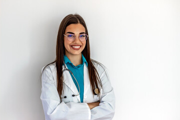 Cropped shot of an cheerful female doctor wearing glasses and smiling towards camera. Pretty young adult Caucasian surgeon smiles cheerfully at the camera. She is wearing a stethoscope and lab coat.