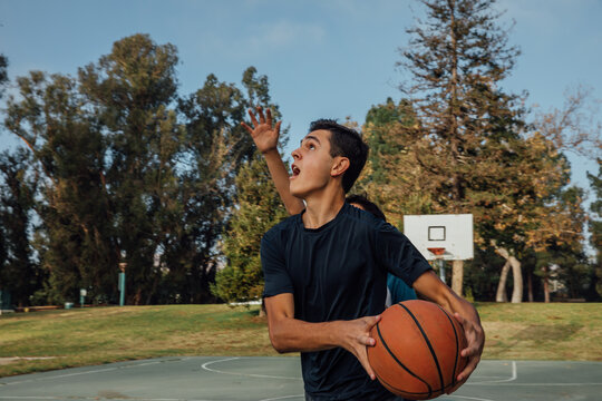 Teenagers Playing Basketball