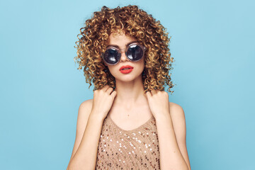 Cheerful woman Curly hair dark round glasses elegant style bright makeup 