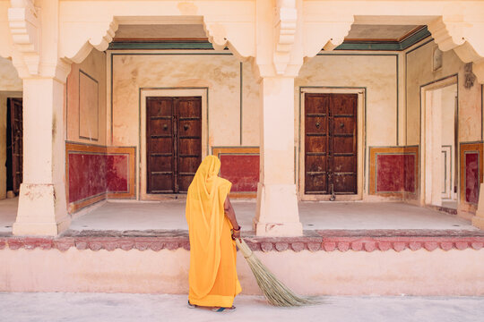 Woman in sari cleaning the fort