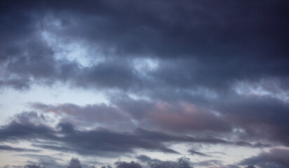Naklejka na ściany i meble Dramatic magical sunrise cloudscape over blue gray color cloudy sky