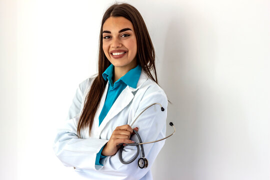 Photo of happy successful young female doctor holding a stethoscope. Women doctor holding stethoscope isolated grey white background. Girl doctor holding a stethoscope in hand. Healthcare and medicine