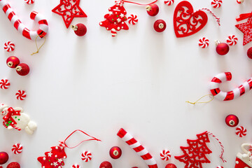 Christmas baubles and candies flat lay against white background, xmas frame, card template