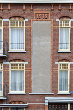 four windows in 1912 building in Amsterdam