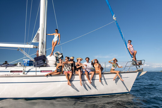 Friends Enjoying Summer Holiday On Sailboat