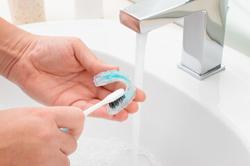 Washing and removing organic residues in orthodontic appliance. Sanitizing denture or bite with...