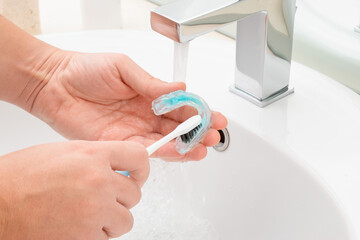 Washing and removing organic residues in orthodontic appliance. Sanitizing denture or bite with...