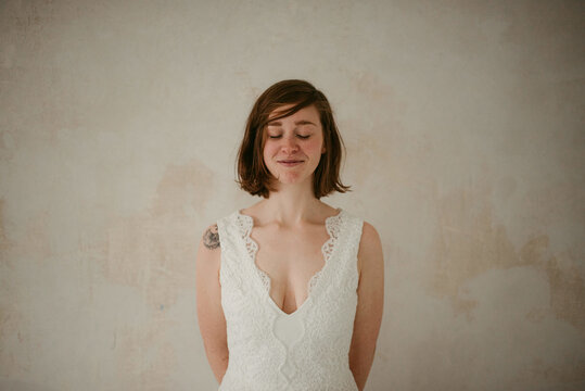 Satisfied tattooed bride with closed eyes