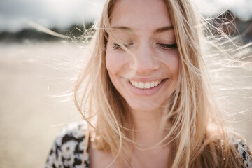 Happy woman enjoying breeze on beach
