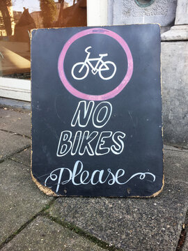 sign with text 'no bikes please'
