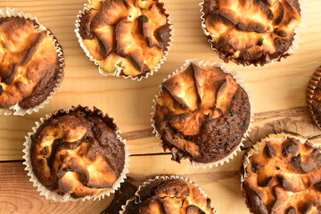 Fragrant chocolate curd muffins, close-up, on a  wooden table.