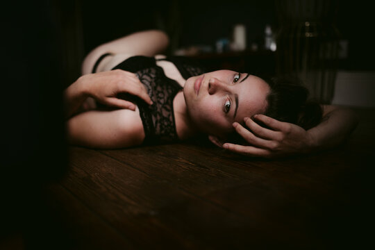 Seductive woman in lingerie lying on floor