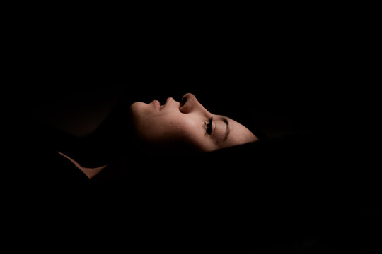 Serene adult relaxed woman against dark background