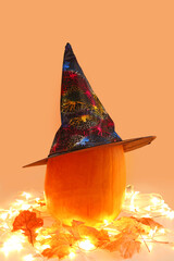 Fototapeta premium halloween pumpkin with autumn leaves and lights