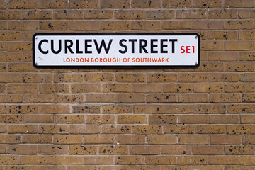 Fototapeta na wymiar Curlew Street plate in a brick