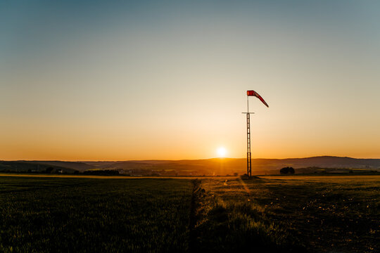 Majestic sunset sky over green airport field in countryside