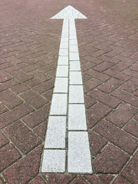 arrow on brick road