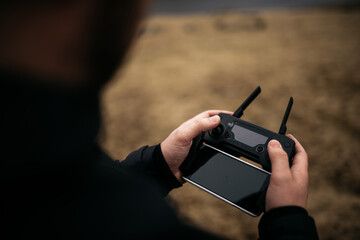 Man using remote control of drone in nature