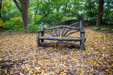 A bench along a path in the Ramble inside Central Park, New York City