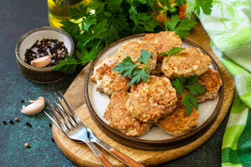 Healthy vegan food. Red fish cutlets on a dark stone or slate table.