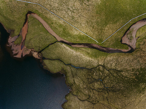 Aerial landscape of river delta in mountainous terrain