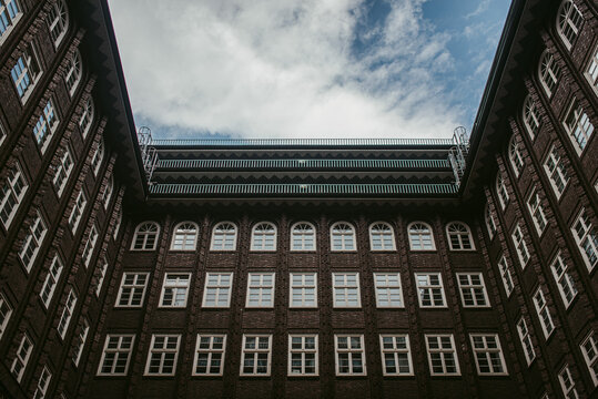 Aged office building against cloudy sky
