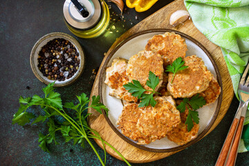Healthy vegan food. Red fish cutlets on a dark stone or slate table. Top view flat lay background.