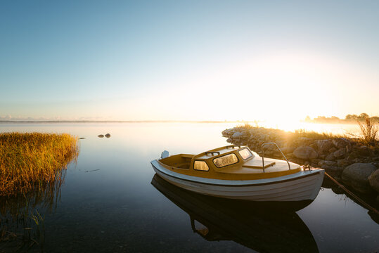 Modern boat in bay during sunrise in autumn