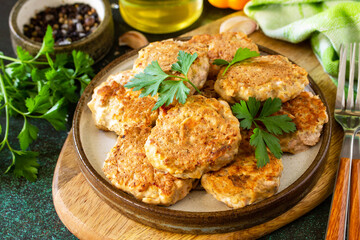 Healthy vegan food. Red fish cutlets on a dark stone or slate table.