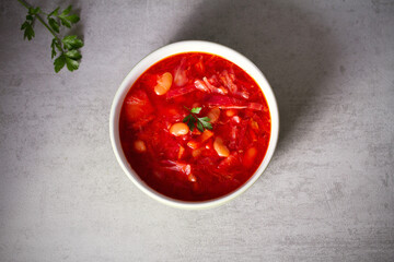 Beetroot soup made with vegetables beans and meat: borsht, bortsch, borshch, borscht. Flat lay, layout, overhead