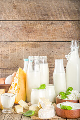 Set of Various Fresh Dairy Products - milk, cottage cheese, cheese, eggs, yogurt, sour cream, butter on wooden background