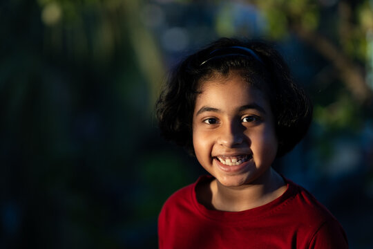 Smiling portrait of cute little girl looking at camera