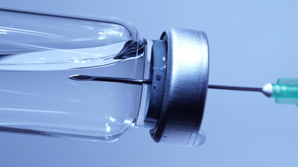 Filling syringe with vaccine from vial, extreme macro. Administrating medication with sterile...