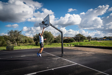 Man shooting the ball in a basketball court