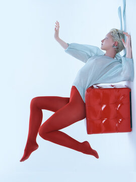 Young beautiful albino woman in red legging dancing modern ballet.
