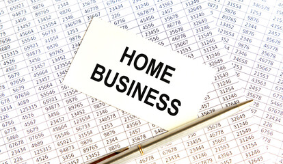 Obraz premium On the business card the text of HOME BUSINESS, all against the background of reports and pens.