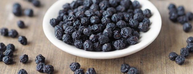Home preparation of dried fruits.Wooden background with dried bird cherry.