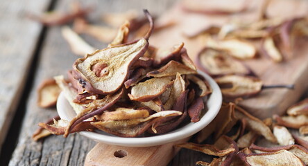 Dried pear on a wooden ancient background. Home harvesting dried fruits.