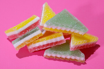 Heap of triangular jelly candy on pink background. 
