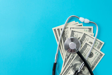 Medical business and finance concept. Stethoscope and money on a blue background.