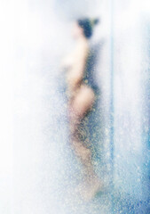Silhouette of a naked girl in the shower. 
Blur effect