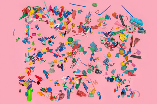 Pieces of colourful plastic on the pink background