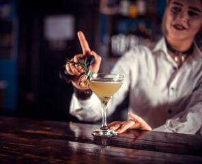 Portrait of girl bartending is pouring a drink in the pub
