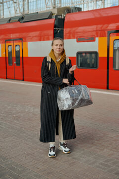 woman stands on an empty platform and waits for a high-speed train. no people at the train station due to the covid-19 coronavirus pandemic in moscow russia